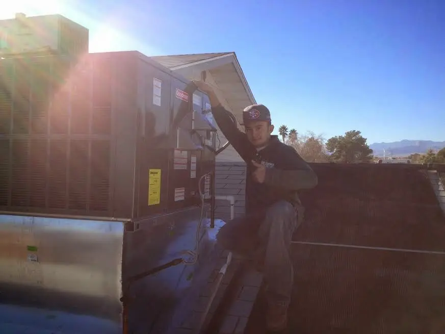 HVAC technician performing AC Tune-Up on a rooftop unit in Fort Myers Beach